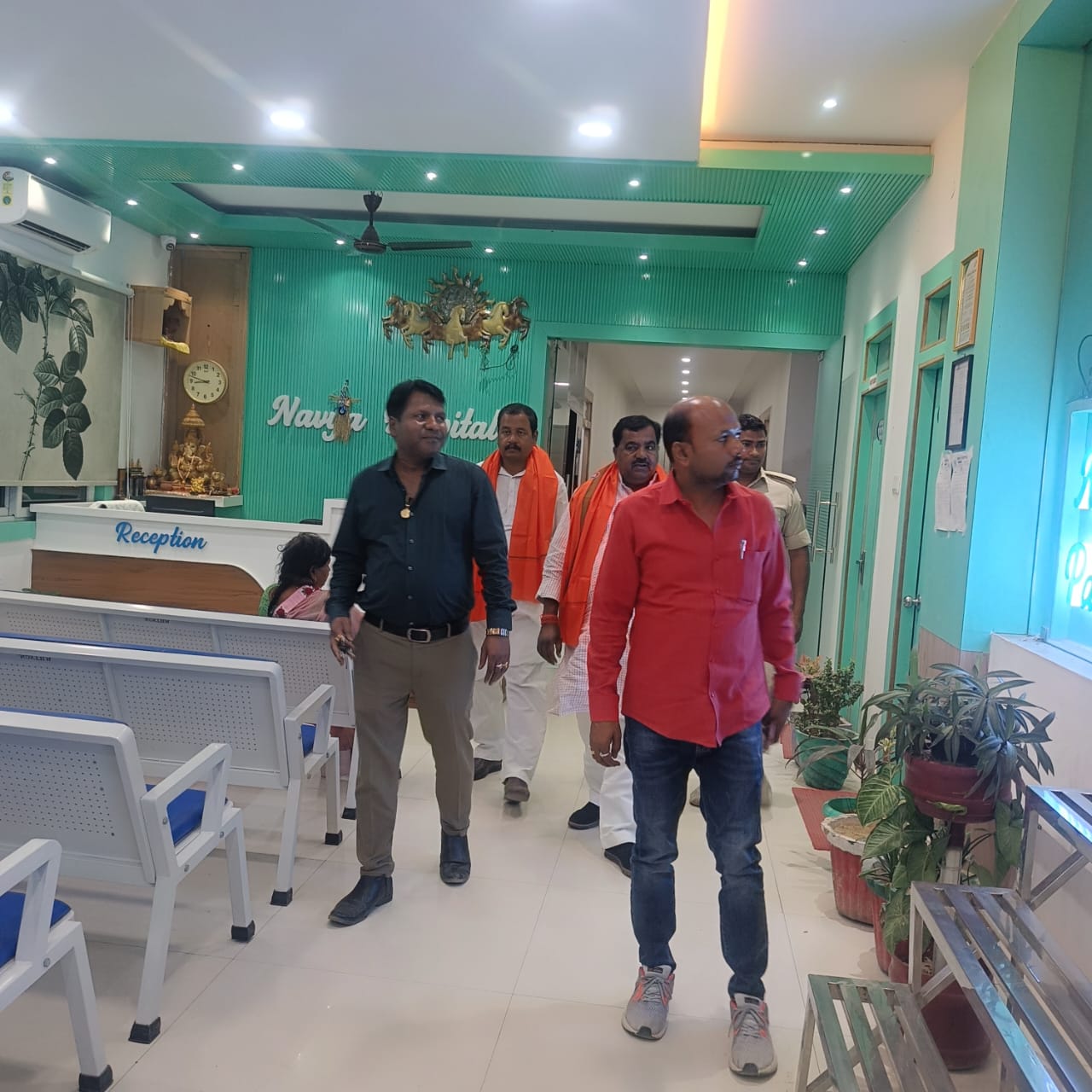 Dignitaries and visitors at Navya Hospital reception lobby during facility tour